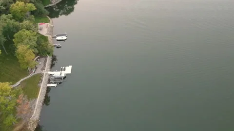 Sunset over Summer Lake Drone Aerial View Tilt Up Stock Footage 145240254
