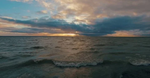 Sunset over Swedish lake, light beams shining through cloudscape. Stock Footage 84500976