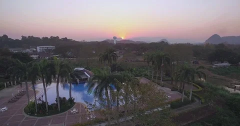 Sunset Over Swimming Pool in Chiang Rai Province, Thailand, Ascending Aerial Stock-Footage 78224653