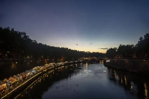 Sunset over the Tiber River, evening rest at a riverside cafe in Rome, Italy Stock Photos