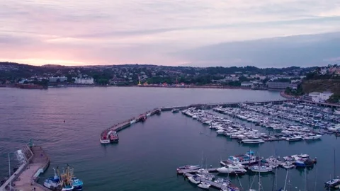 Sunset over Torquay Marina from a drone, English Riviera, Torbay, Devon, England 動画素材 207587683