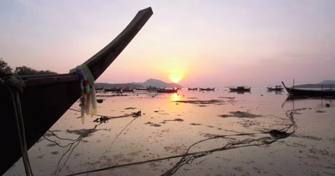 Sunset Over Traditional Thai Longtail Boats in Phuket Pullback Reveal Shot Stock Footage 64931968