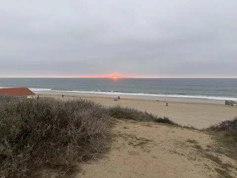 Sunset Over the Tranquil Beach Creates a Serene Evening Atmosphere Stock Photos