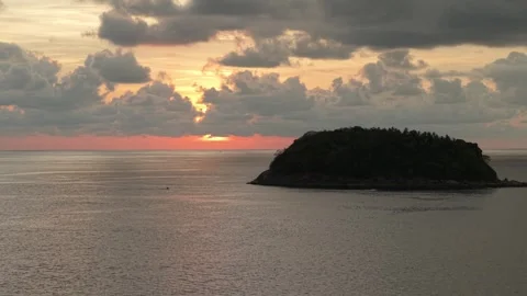 Sunset over tranquil ocean with island silhouette and colorful clouds Stock Footage 342332114