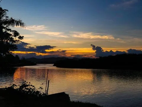 Sunset over a tranquil river Stock Photos