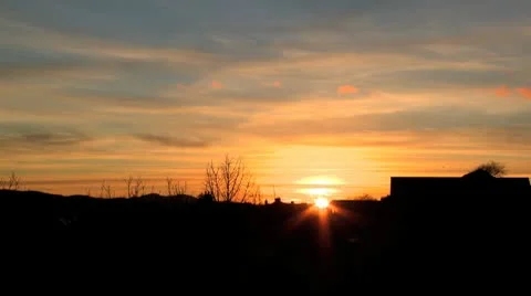 Sunset over trees and buildings. Time lapse. Stock Footage 10709892