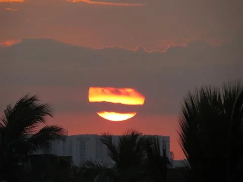 Sunset over the trees Stock Photos