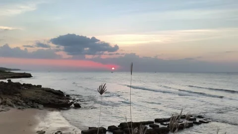 Sunset Over Tropical Ocean Beach with Rocky Shoreline Stock Footage 341505699