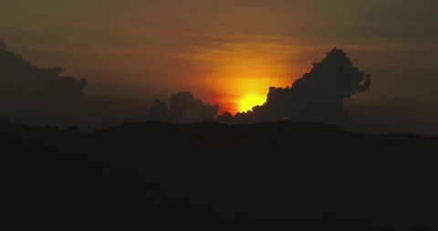 Sunset Over Tropical Rainforest with Dramatic Light and Shadow Aerial Stock-Footage 332348469