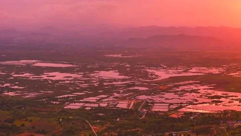 Sunset over valley with glowing reflections in lakes and mountains in background Stock-Footage 320286919