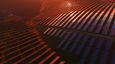 Sunset over vast solar farm creates a stunning landscape of renewable energy Stock Footage 332014723