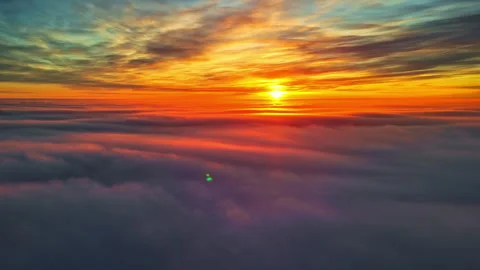 Sunset over vibrant clouds in the sky with golden and purple hues during golden Stock Footage 304404284