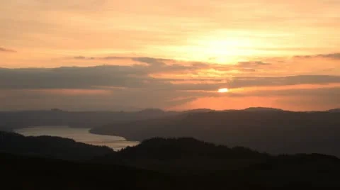 Sunset over water and forest Stock Footage 21894664