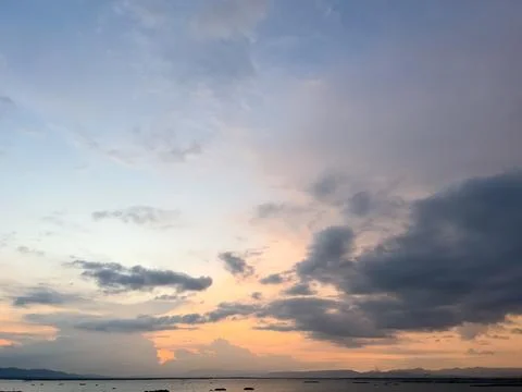 Sunset Over Water With Dramatic Clouds Stock Photos