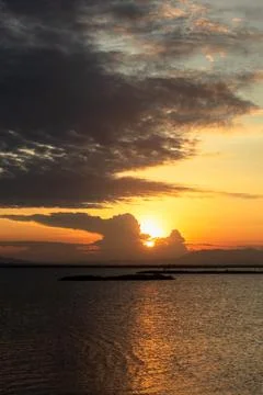 Sunset Over Water with Dramatic Clouds 库存照片