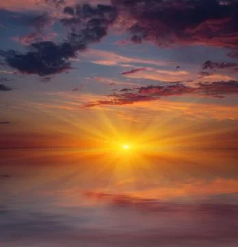 Sunset over water Stock Photos