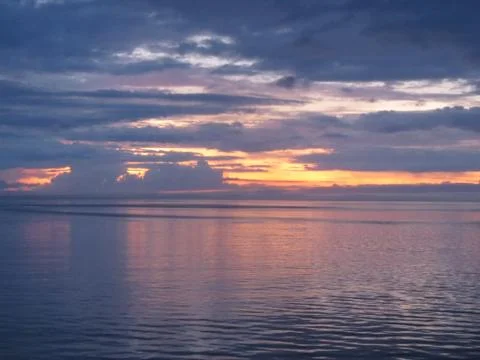Sunset over water Stock Photos
