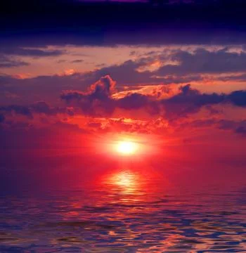 Sunset over water surface Stock Photos