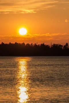 Sunset over water - vertical Stock Photos