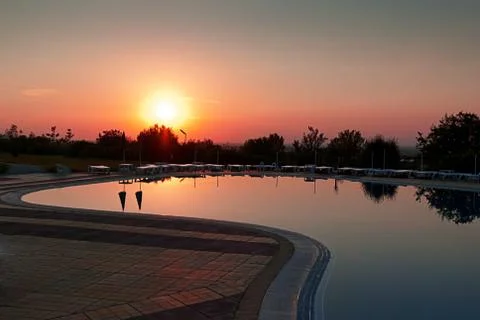 Sunset over the waterpool Stock Photos