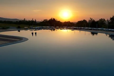 Sunset over the waterpool Stock Photos