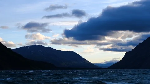 Sunset over wave covered lake with light beam light the background Stock Footage 95823998