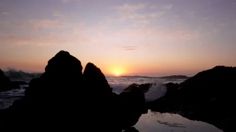 Sunset over waves and rocks Stock Footage 234630917