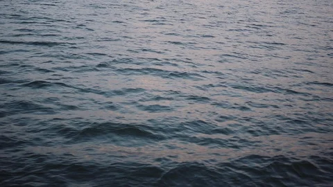 Sunset over the waves of the sea of galilee Super Slo Mo Stock Footage 86071470