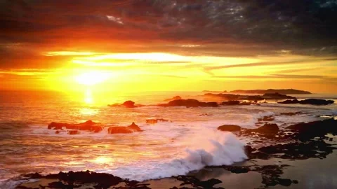 Sunset Over Wavy Beach with Cloudy Sky and Rocks Stock Footage 279844126