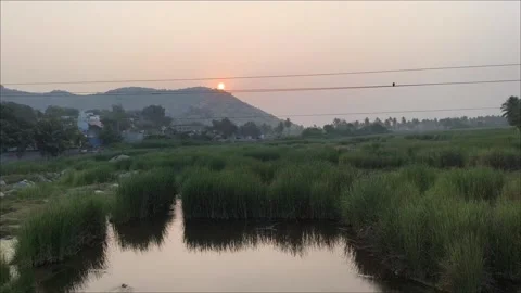 Sunset Over Wetland With Reflection and Distant Hills 库存影片 330326050