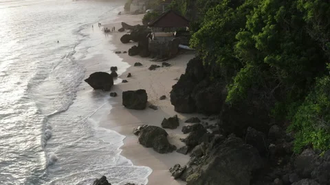 Sunset over a white sand beach along the cliff in Bali Stock Footage 147905814