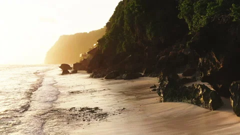 Sunset over a white sand beach along the cliff in Bali Stock Footage 147905864