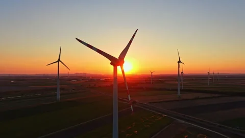 Sunset over wind turbines in a field Stock Footage 344261491