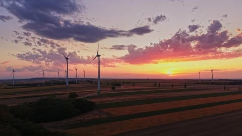 Sunset over wind turbines in a rural landscape during evening hours 動画素材 343123157
