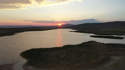 Sunset Over Winding Water Channels In Dried Lake Basin Stock Footage 324700708