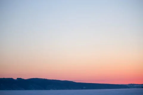 Sunset over the winter field Stock Photos