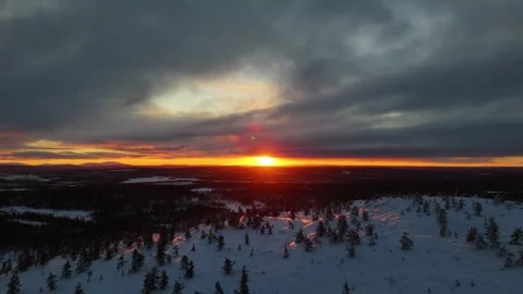 Sunset over winter forest and snowy mountain top in lapland, aerial drone video Stock Footage 301327972