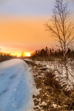 Sunset over the winter road 写真素材