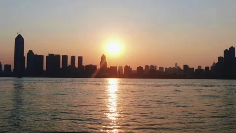 Sunset Over Yangtze River with City Skyline and Water Reflections Stock Footage 342240915