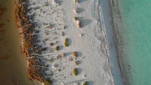 Sunset overhead aerial drone view of caribbean white sand beach and light blue Stock Footage 117212386