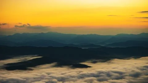 Sunset overlooking mountains with Mist Stock Photos