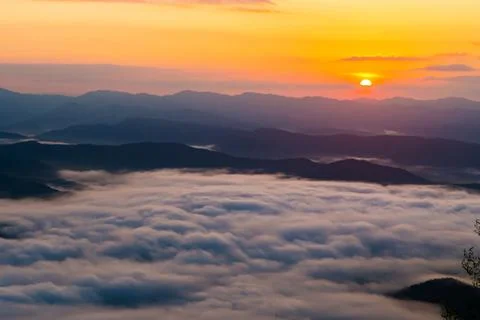 Sunset overlooking mountains with Mist Stock Photos