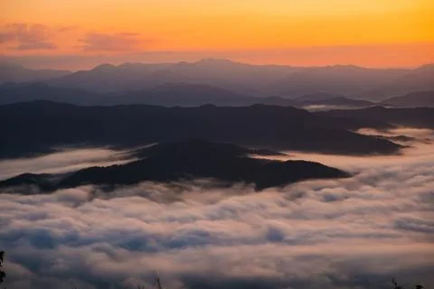 Sunset overlooking mountains with Mist Stock Photos