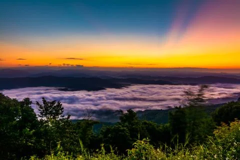 Sunset overlooking mountains with Mist Stock Photos