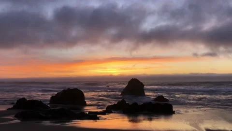 Sunset on the Pacific Ocean in California. Waves roll on the shore. Clouds float Stock Footage 187762186
