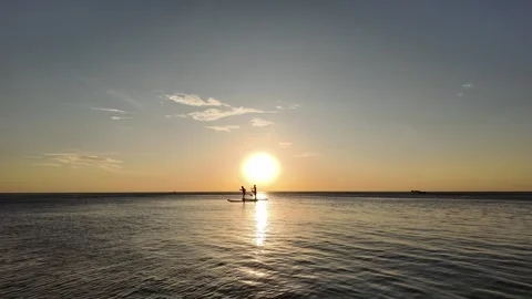 Sunset Paddleboarding Silhouettes in Tranquil Waters Stock Footage 259688466