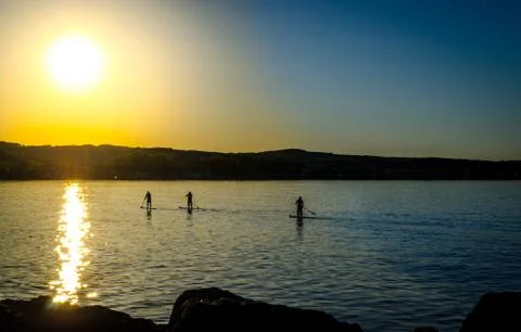 Sunset paddlers Stock Photos