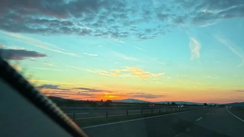 Sunset paints highway sky with soft orange and blue. Serbia Stock Footage 340639133
