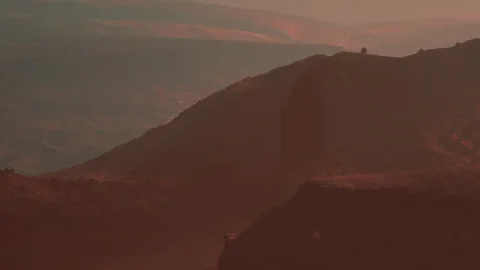 Sunset Paints the Mountains in Warm Hues Near a Tranquil Valley Stock Footage 344954458