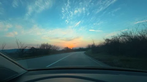 Sunset paints sky with orange, blue, and soft white clouds 스톡 동영상 331063444
